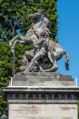 Statue of horse and man struggling in Paris, France.
