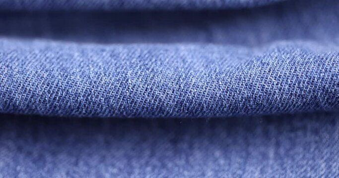 close-up of a new blue denim fabric, part of a pair of blue denim pants