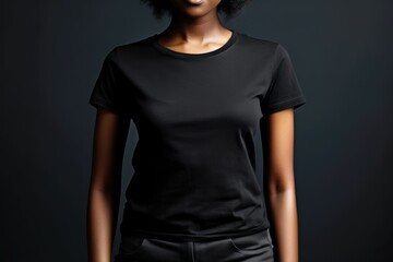 Black woman model wearing a plain black short sleeved t-shirt, isolated on a blank background. Mock-up, torso only. Generative AI illustration.