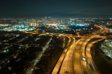 Fototapeta premium Aerial view of american highway junction at night with fast driving vehicles in Tampa, Florida. View from above of USA transportation infrastructure
