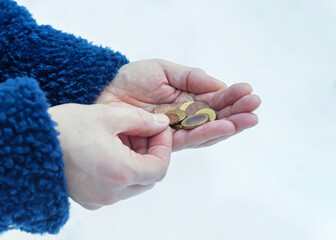 Coins in female hands, selective focus.	