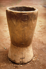 An old wooden stupa with a wooden pestle in it
