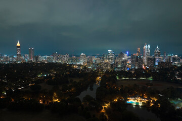 Fototapeta premium Night urban landscape of downtown district of Atlanta city in Georgia, USA. Skyline with brightly illuminated high skyscraper buildings in modern american megapolis