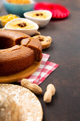 Festa Junina Summer Festival Carnival concept. Brazilian straw hat, popcorn, peanuts and Corn Cake on Wooden Background for Brazilian Festa Junina Summer Festival