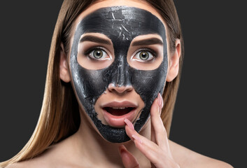 Cosmetologist doing carbon peeling procedure to beautiful girl in a spa salon. Hardware cosmetology treatment.