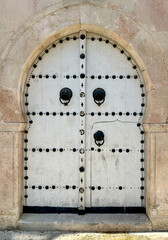 White Tunisian Keyhole Door with Black Studs in Tunis Medina, Portrait