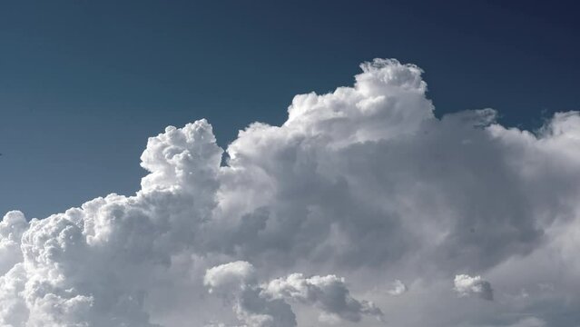 Slow motion shot of clouds moving in the blue sky