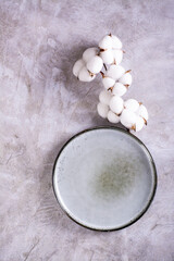 Mockup of empty ceramic plate and cotton branch on gray background top and vertical view