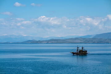 Black ship on the background of the blue sea. As a background just beautiful