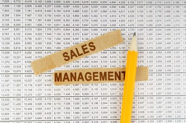 On the documents with reports are a pencil and strips of paper with the inscription - Sales...