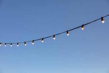 light bulbs garlands against sky