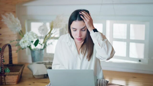 Upset young woman read bad news on laptop look desperate, Unhappy person use computer technology at home, Worried girl stress at freelance work at home workplace, File error	