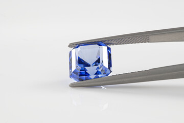 Blue Precious Gemstone in Tweezers