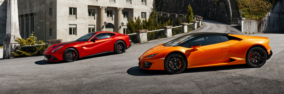 Yellow Lamborghini Huracan and Red Ferrari f12 parked in front of the Vemork Museum. Rjukan, Norway - 04.06.2016: