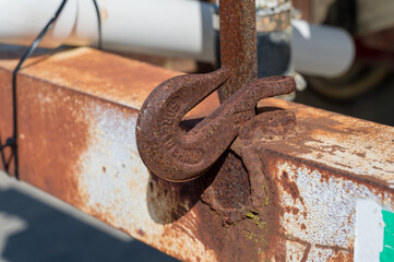 Steel hook welded onto a bumper used to secure a chain on equipment