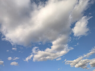 Compact dense mass of clouds move across the blue sky