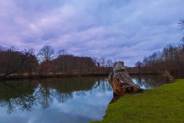 Landscape by the water. Stara Dyje river near Genoa castle in Czech republic. Trees are reflected in the river. Calm water. Colorful autumn. Beautiful clouds in the sky.