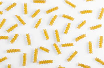 Pasta products in the form of a spiral, texture, on a white background