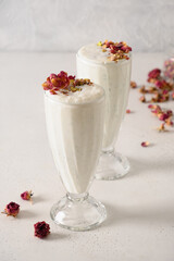Indian Sweet lassi with saffron and rose water on white background. Vertical format. Traditional...