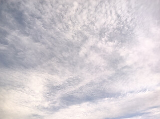 Pellets of clouds all over the sky have covered the entire sky as the sunlight shines through the clouds