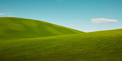 Green rolling hills of Tuscany region in Italy