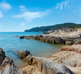 Fototapeta na wymiar Summer morning sandy beach and rocky coast near Platanitsi Beach (Sithonia Peninsula, Chalcidice, Greece).