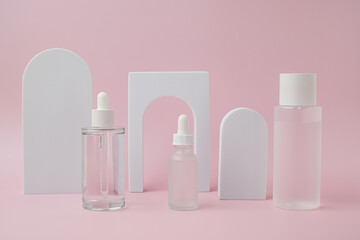 The set of skincare and cosmetic bottle display on the pink background for beauty concept.
