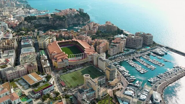Aerial view of Monaco City and The Stade Louis II Stadium venue for football, home of AS Monaco, located in the Fontvieille district ft. famous Monte-Carlo, Cap d&rsquo;Ail Marina, Monaco Ville 4K UHD 
