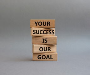 Your success is our goal symbol. Wooden blocks with words Your success is our goal. Beautiful grey background. Business and Your success is our goal concept. Copy space