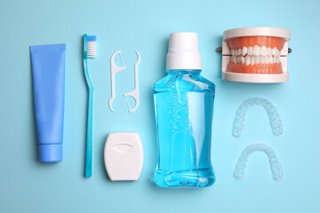 Transparent plastic dental aligners and care products on a colored background