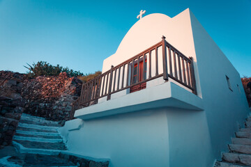 mall white chapel in Plaka town on Milos island in Greece in sunset light - 593380406