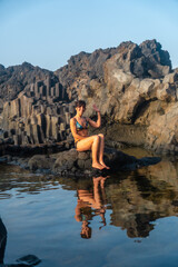 Sunset on El Hierro Island. Canary Islands, a tourist woman bathing in the natural pool of Charco Azul