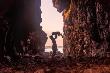 Foto auf Acrylglas Kanarische Inseln El Hierro Island. Canary Islands, mother and son in a sea cave of Charco Azul in the sunset