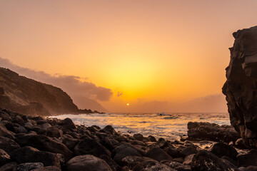 Obraz premium El Hierro Island. Canary Islands, landscape of stones next to Charco azul in spring orange sunset