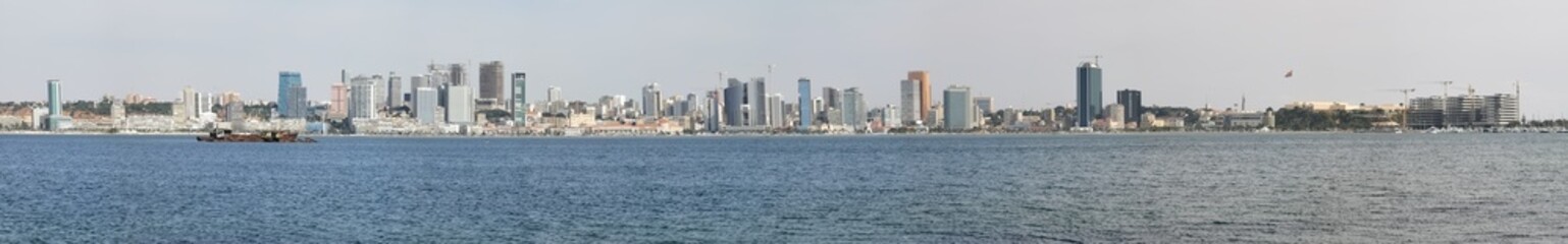 Fototapeta na wymiar Panoramic view at the Luanda downtown, with cityscape skyline buildings, Luanda bay , Cabo Island and Port of Luanda, Luanda fortress, marginal and historical central buildings, in Angola