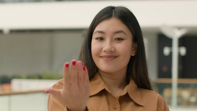 Asian woman point finger at camera hey you gesture invite to join chinese korean japanese girl businesswoman inviting come here smiling lady female HR manager of business office firm calling welcome