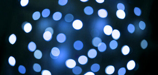 Abstract festive elegant blue background of blurred with bokeh lights and stars texture, banner