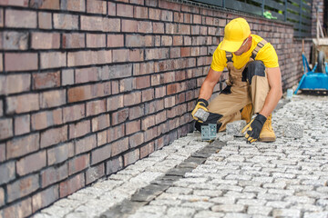 Professional Contractor Laying Paving Stones