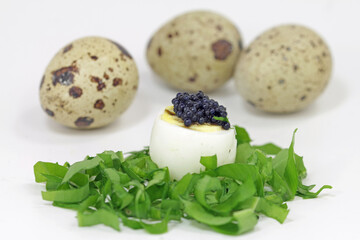 Quail egg with wild garlic and caviar substitute.