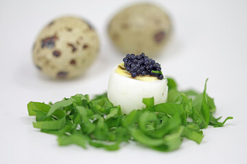 Quail egg with wild garlic and caviar substitute.