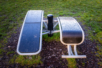 Close up of outdoor gym exercise sport equipment at public park. Weights and resistance training.