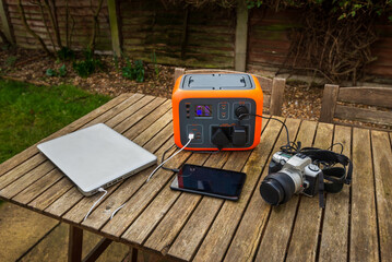 Portable power station solar electricity generator with laptop, tablet and camera charging. 