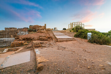 Late afternoon colorful skies over the Temple of Poseidon at Cape Sounion, on the Riviera coastline near Athens, Greece.
