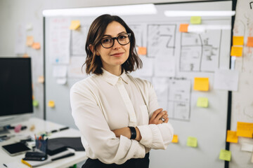 Confident and stylish female copywriter in a modern office space surrounded by whiteboards, brainstorming sessions and creative ideas, generative ai