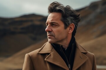 Portrait of a handsome middle-aged man in a brown coat. Men's beauty, fashion.