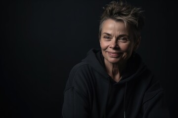Fototapeta premium Portrait of a beautiful middle-aged woman in a black hoodie