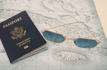 US Passport and Sunglasses on Old Map