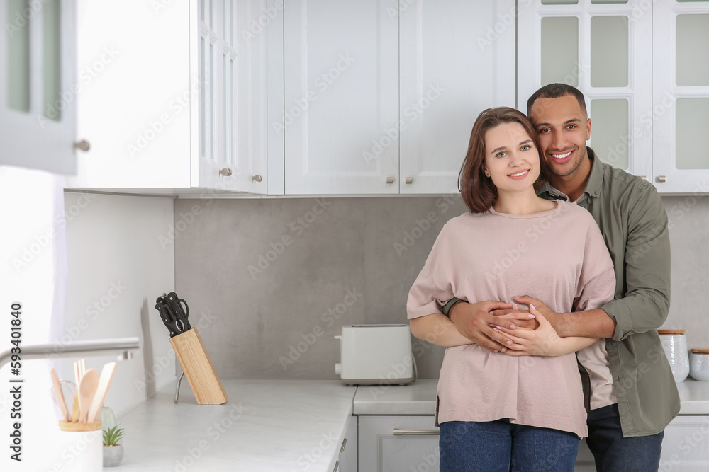 Wall mural Dating agency. Lovely couple embracing in kitchen, space for text