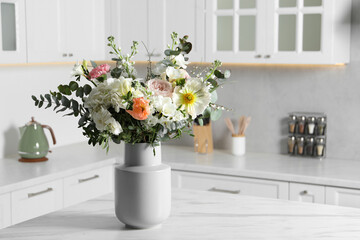 Fototapeta na wymiar Bouquet of beautiful flowers on white table indoors. Space for text