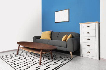 Stylish living room interior with comfortable sofa and coffee table